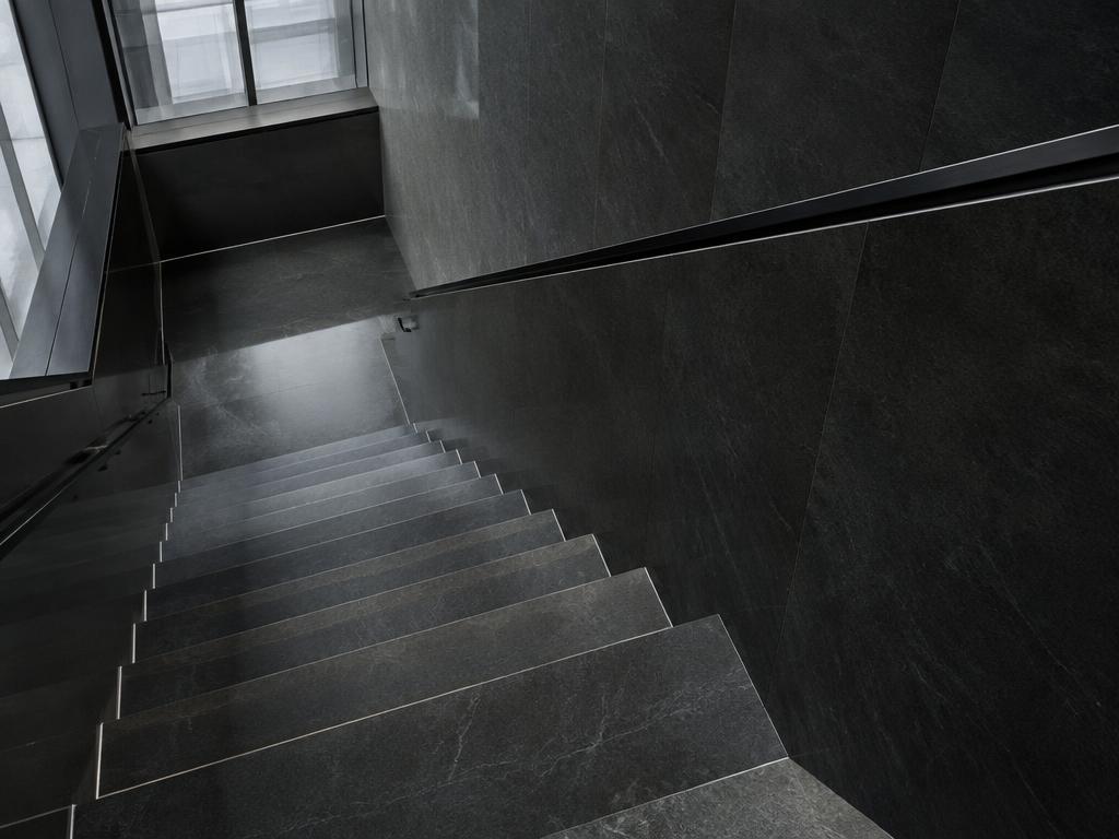 Descending dark stone staircase