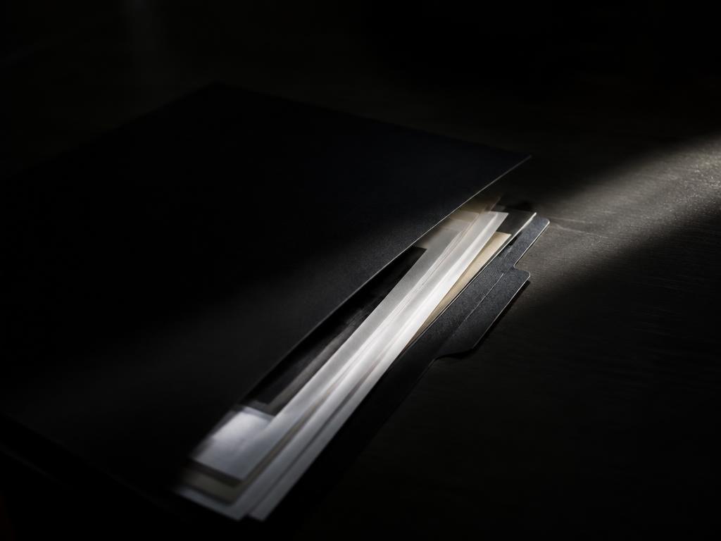 Partially opened document folder under focused light